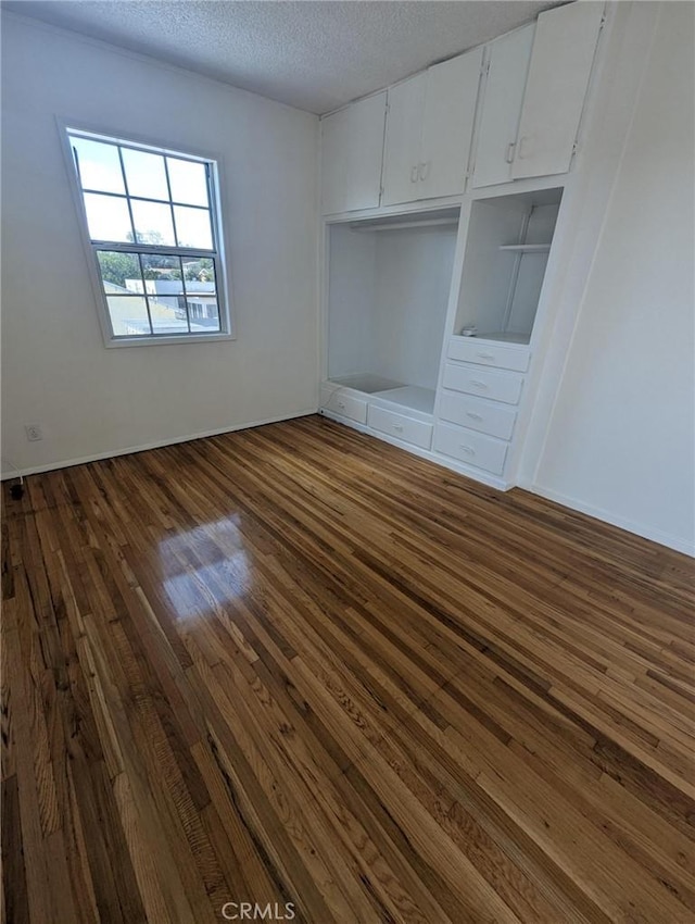891 W Elberon Ave, San Pedro, CA 90731 - unfurnished bedroom with dark wood-type flooring and a textured ceiling