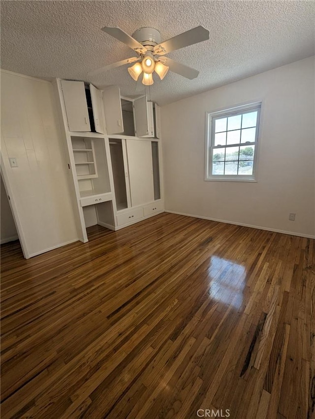 891 W Elberon Ave, San Pedro, CA 90731 - unfurnished bedroom featuring dark wood finished floors, a textured ceiling, and a ceiling fan