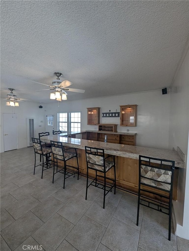 891 W Elberon Ave, San Pedro, CA 90731 - dining area featuring a textured ceiling and a ceiling fan