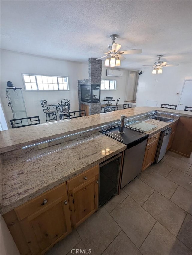 891 W Elberon Ave, San Pedro, CA 90731 - kitchen featuring ceiling fan, healthy amount of natural light, a textured ceiling, a fireplace, and light tile patterned floors