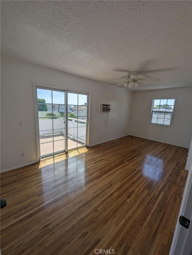 891 W Elberon Ave, San Pedro, CA 90731 - spare room with a textured ceiling, dark wood finished floors, a ceiling fan, and a wall mounted AC