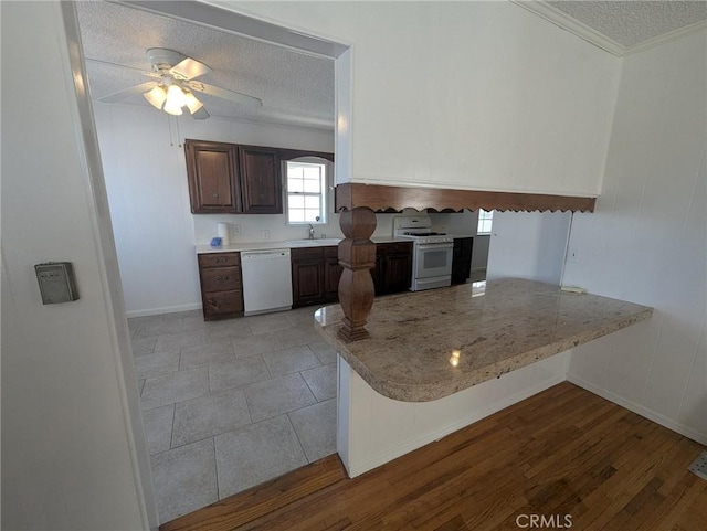 891 W Elberon Ave, San Pedro, CA 90731 - kitchen featuring white appliances, a textured ceiling, a peninsula, dark brown cabinets, and ceiling fan