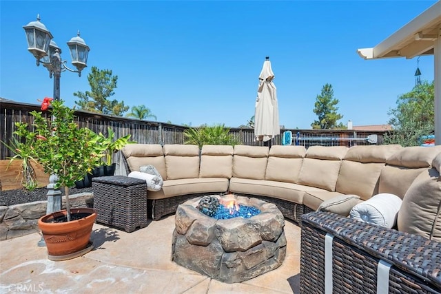 185 Alabaster Loop, Perris, CA 92570 - fenced backyard featuring an outdoor living space with a fire pit and a patio area