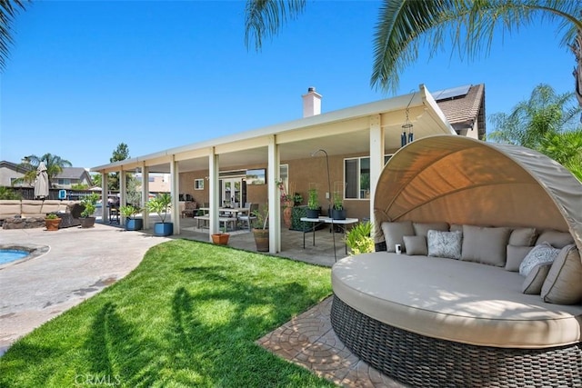 185 Alabaster Loop, Perris, CA 92570 - back of property with a patio, french doors, a chimney, an outdoor living space, and a lawn