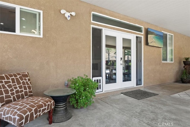 185 Alabaster Loop, Perris, CA 92570 - doorway to property with french doors, a patio area, and stucco siding