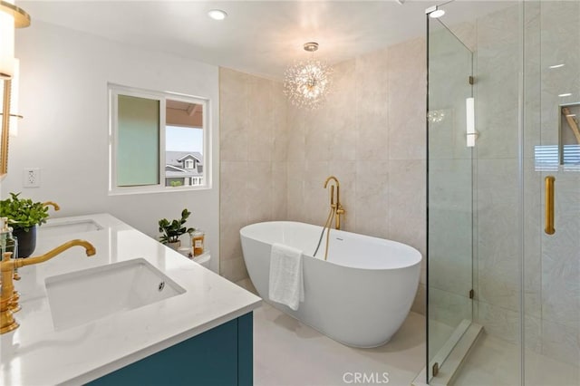 17698 Locust St, Fountain Valley, CA 92708 - full bathroom featuring double vanity, a freestanding bath, a stall shower, tile walls, and recessed lighting