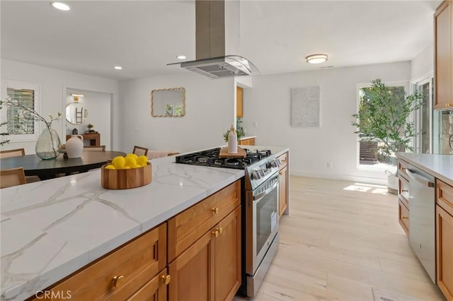 17698 Locust St, Fountain Valley, CA 92708 - kitchen featuring appliances with stainless steel finishes, island exhaust hood, recessed lighting, light stone counters, and light wood finished floors