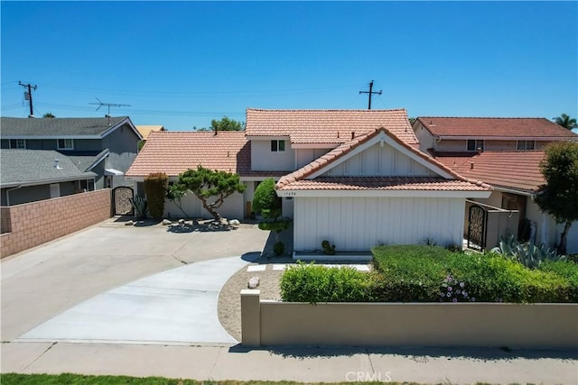 17698 Locust St, Fountain Valley, CA 92708 - view of front of property with board and batten siding, a tile roof, and a gate