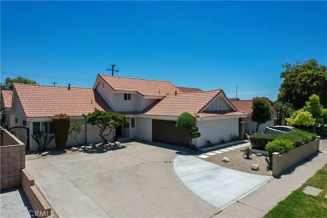 17698 Locust St, Fountain Valley, CA 92708 - view of front of home featuring a tiled roof, concrete driveway, a garage, and stucco siding
