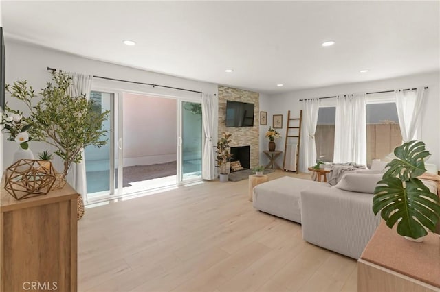17698 Locust St, Fountain Valley, CA 92708 - living room featuring light wood-type flooring, a stone fireplace, and recessed lighting