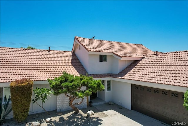17698 Locust St, Fountain Valley, CA 92708 - view of front of house with a tile roof, a garage, and stucco siding