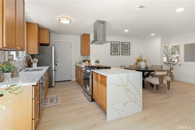 17698 Locust St, Fountain Valley, CA 92708 - kitchen featuring island exhaust hood, stainless steel appliances, light wood finished floors, plenty of natural light, and recessed lighting