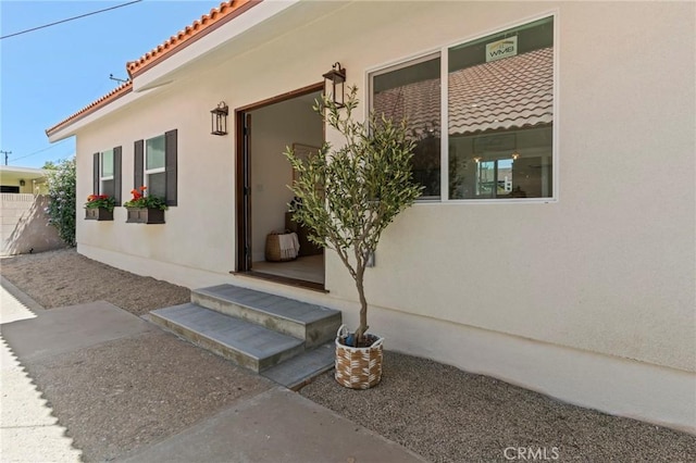17698 Locust St, Fountain Valley, CA 92708 - view of exterior entry featuring a tiled roof and stucco siding