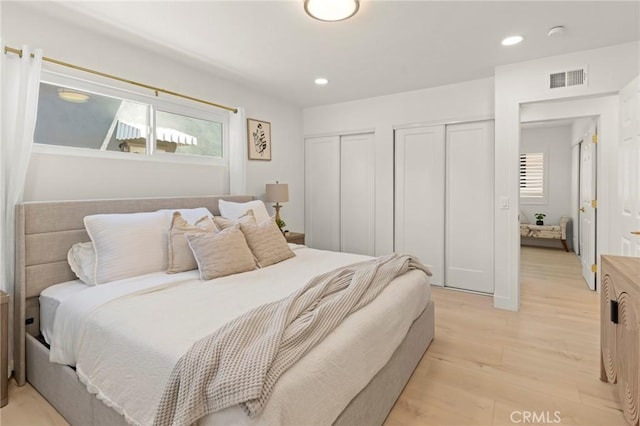 17698 Locust St, Fountain Valley, CA 92708 - bedroom featuring two closets, multiple windows, light wood-type flooring, and recessed lighting