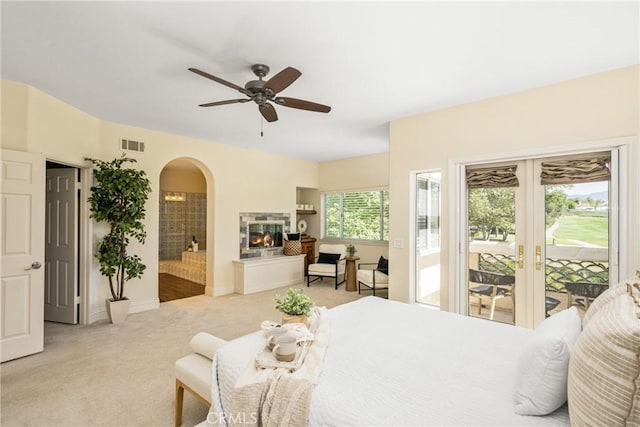 2 Via Barcaza, Coto De Caza, CA 92679 - bedroom with arched walkways, access to outside, light carpet, a multi sided fireplace, and ensuite bath