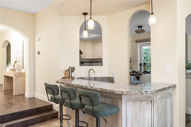 2 Via Barcaza, Coto De Caza, CA 92679 - indoor wet bar featuring wood finished floors, arched walkways, and pendant lighting