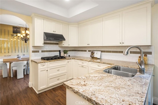 2 Via Barcaza, Coto De Caza, CA 92679 - kitchen featuring under cabinet range hood, black gas stovetop, cream cabinetry, and a chandelier