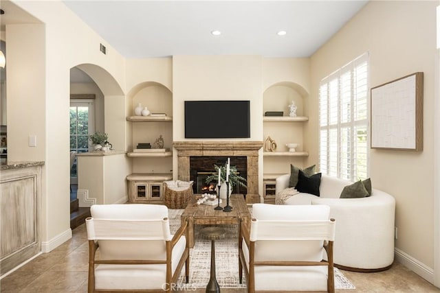 2 Via Barcaza, Coto De Caza, CA 92679 - living area with built in shelves, a lit fireplace, recessed lighting, and tile patterned flooring