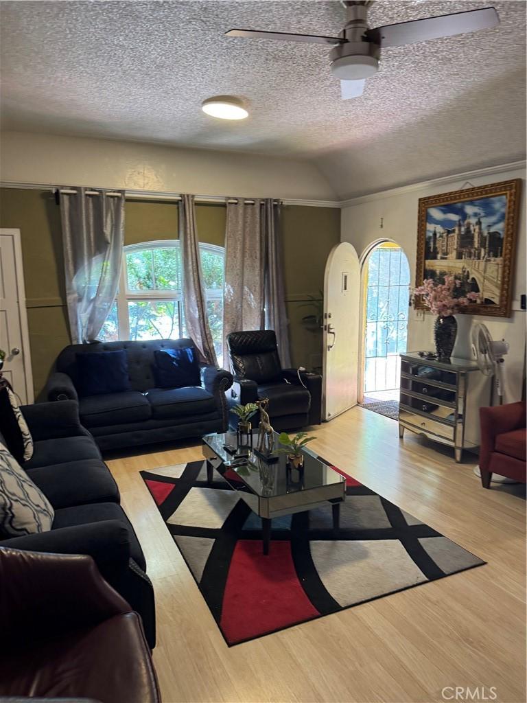 1917 Rousselle St, Santa Ana, CA 92707 - living room with plenty of natural light, wood finished floors, a textured ceiling, a ceiling fan, and lofted ceiling