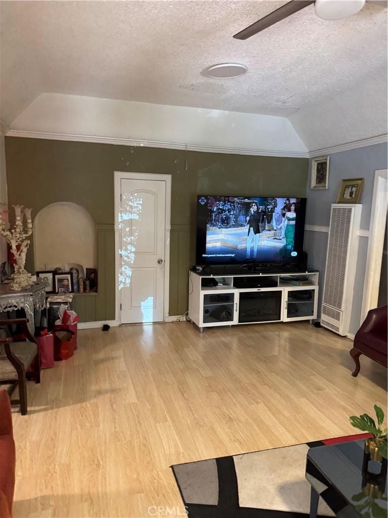 1917 Rousselle St, Santa Ana, CA 92707 - living room featuring a heating unit, wood finished floors, vaulted ceiling, ornamental molding, and ceiling fan