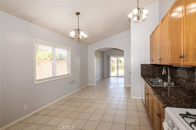 24691 Tarazona, Mission Viejo, CA 92692 - kitchen with a chandelier, arched walkways, healthy amount of natural light, stove, and vaulted ceiling