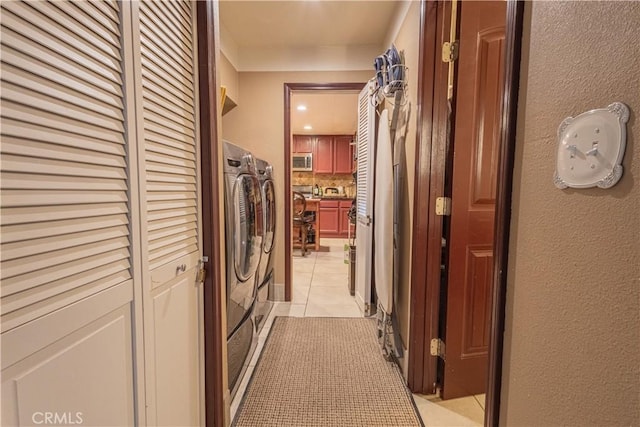 24000 Wheatfield Cir, Wildomar, CA 92595 - laundry area with washer and dryer, light tile patterned floors, and a textured wall