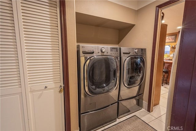 24000 Wheatfield Cir, Wildomar, CA 92595 - laundry area featuring washer and dryer and light tile patterned floors