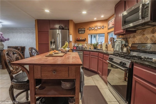 24000 Wheatfield Cir, Wildomar, CA 92595 - kitchen featuring stainless steel appliances, butcher block counters, light tile patterned floors, backsplash, and recessed lighting