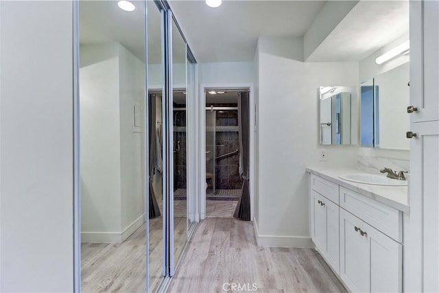 3365 Punta Alta Unit 2F, Laguna Woods, CA 92637 - full bath featuring vanity, a spacious closet, and wood finished floors