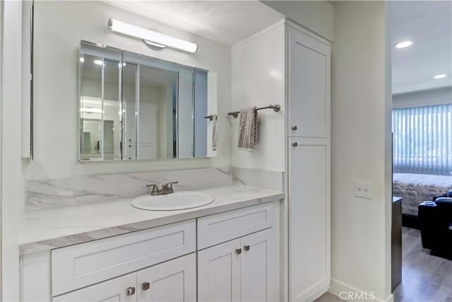 3365 Punta Alta Unit 2F, Laguna Woods, CA 92637 - ensuite bathroom with vanity, recessed lighting, and wood finished floors