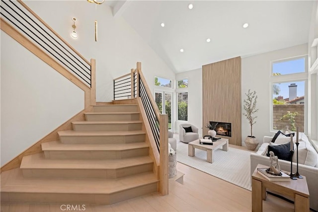 24876 Avenida Avalon, Laguna Hills, CA 92653 - stairs with high vaulted ceiling, wood finished floors, recessed lighting, beam ceiling, and a fireplace