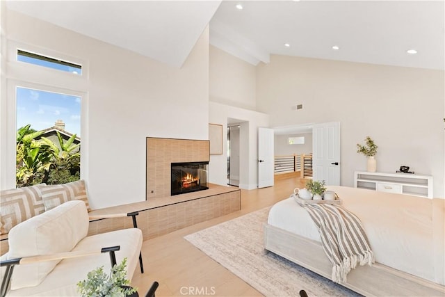 24876 Avenida Avalon, Laguna Hills, CA 92653 - bedroom featuring high vaulted ceiling, a tile fireplace, wood finished floors, recessed lighting, and beam ceiling