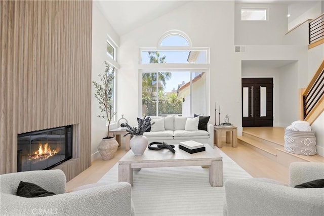 24876 Avenida Avalon, Laguna Hills, CA 92653 - living area with wood finished floors, high vaulted ceiling, stairs, and a fireplace