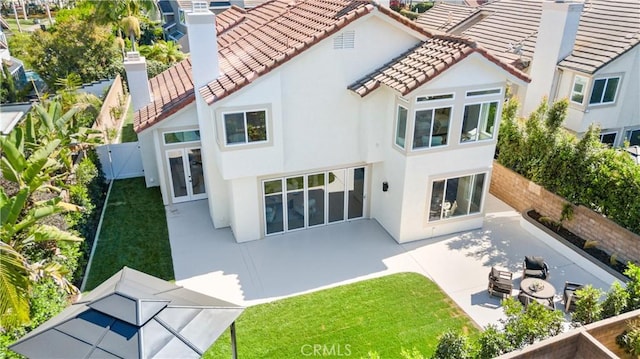 24876 Avenida Avalon, Laguna Hills, CA 92653 - rear view of house featuring a patio, stucco siding, a fenced backyard, a tiled roof, and a chimney