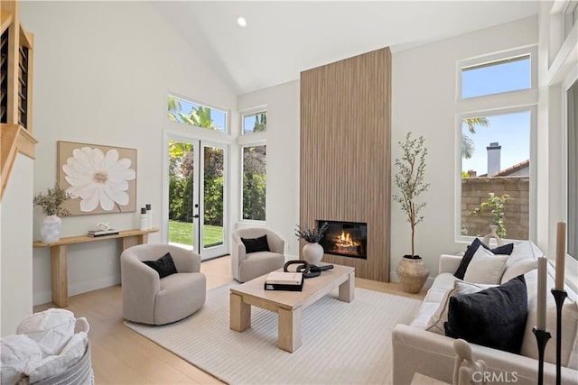24876 Avenida Avalon, Laguna Hills, CA 92653 - living room featuring high vaulted ceiling, a fireplace, wood finished floors, and recessed lighting
