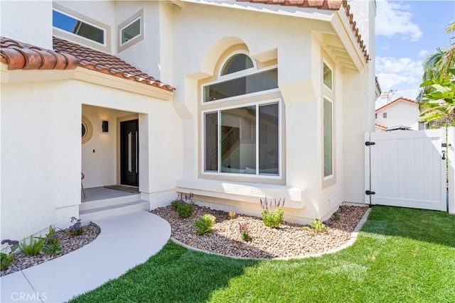 24876 Avenida Avalon, Laguna Hills, CA 92653 - property entrance featuring a tiled roof, stucco siding, and a gate
