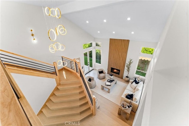 24876 Avenida Avalon, Laguna Hills, CA 92653 - stairs with healthy amount of natural light, recessed lighting, wood finished floors, lofted ceiling, and a large fireplace