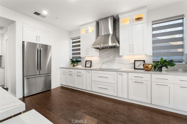 2886 Muir Trail Dr, Fullerton, CA 92833 - kitchen with high end fridge, wall chimney range hood, decorative backsplash, white cabinets, and dark wood-style flooring
