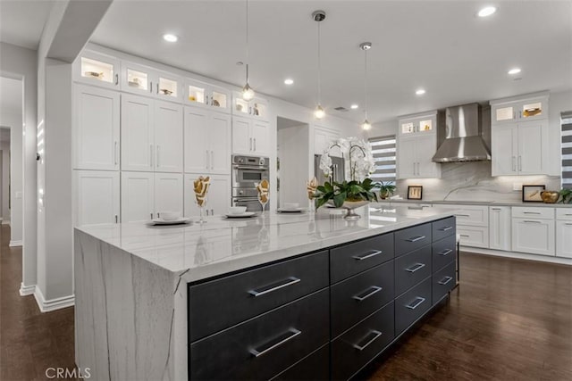 2886 Muir Trail Dr, Fullerton, CA 92833 - kitchen featuring wall chimney range hood, white cabinets, backsplash, dark cabinetry, and dark wood-style flooring