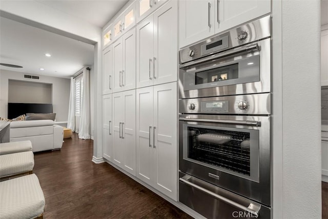 2886 Muir Trail Dr, Fullerton, CA 92833 - kitchen featuring double oven, a warming drawer, dark wood finished floors, white cabinets, and open floor plan