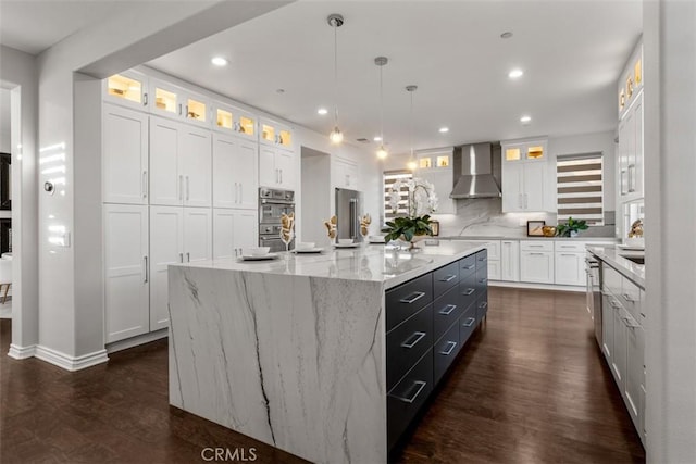2886 Muir Trail Dr, Fullerton, CA 92833 - kitchen with wall chimney range hood, white cabinets, a large island, dark wood finished floors, and recessed lighting