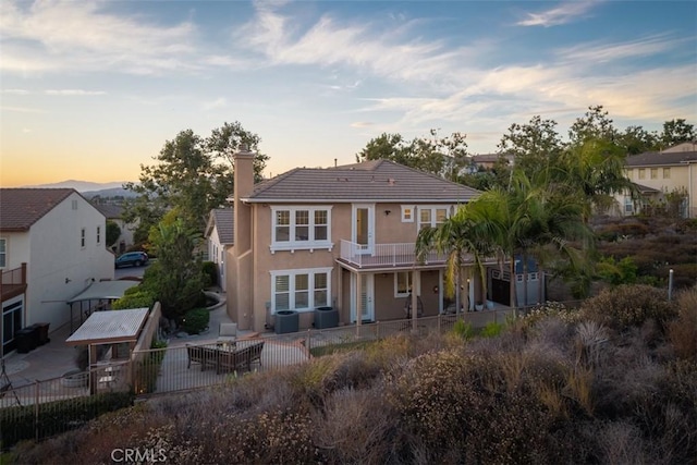 2886 Muir Trail Dr, Fullerton, CA 92833 - rear view of house with a patio area, a chimney, stucco siding, and a fenced backyard