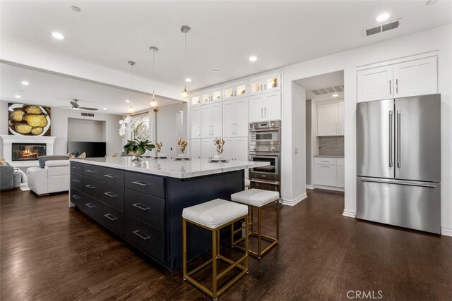 2886 Muir Trail Dr, Fullerton, CA 92833 - kitchen with stainless steel appliances, white cabinets, dark cabinets, dark wood-style flooring, and recessed lighting