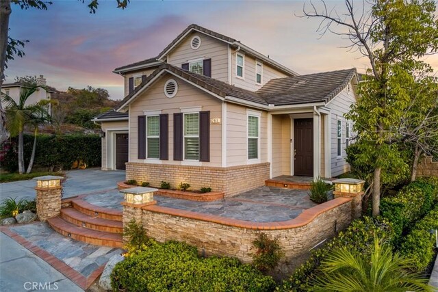 2886 Muir Trail Dr, Fullerton, CA 92833 - view of front facade featuring brick siding and asphalt driveway