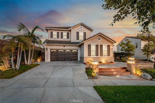2886 Muir Trail Dr, Fullerton, CA 92833 - traditional-style home with concrete driveway, a tile roof, a garage, and brick siding