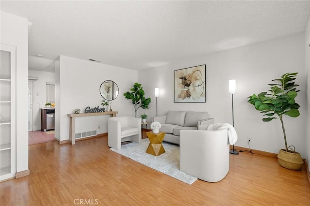 8515 Edgebrook Dr, Garden Grove, CA 92844 - living room featuring light wood finished floors and a textured ceiling