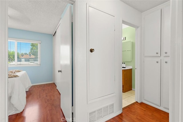 8515 Edgebrook Dr, Garden Grove, CA 92844 - hall featuring light wood finished floors and a textured ceiling