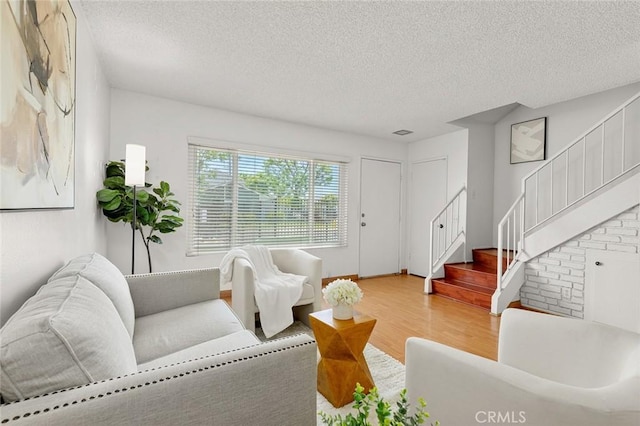 8515 Edgebrook Dr, Garden Grove, CA 92844 - living room featuring a textured ceiling, wood finished floors, and stairway