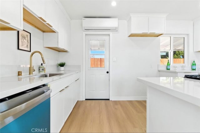 3839 Riverside Dr, Chino, CA 91710 - kitchen with stainless steel dishwasher, a wall mounted air conditioner, light wood-type flooring, white cabinetry, and recessed lighting
