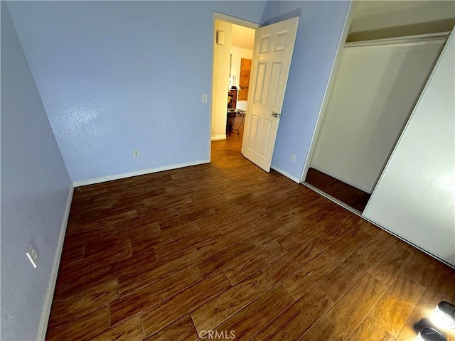 24423 Dunlavy Ct, Moreno Valley, CA 92557 - unfurnished bedroom with wood finished floors and a closet